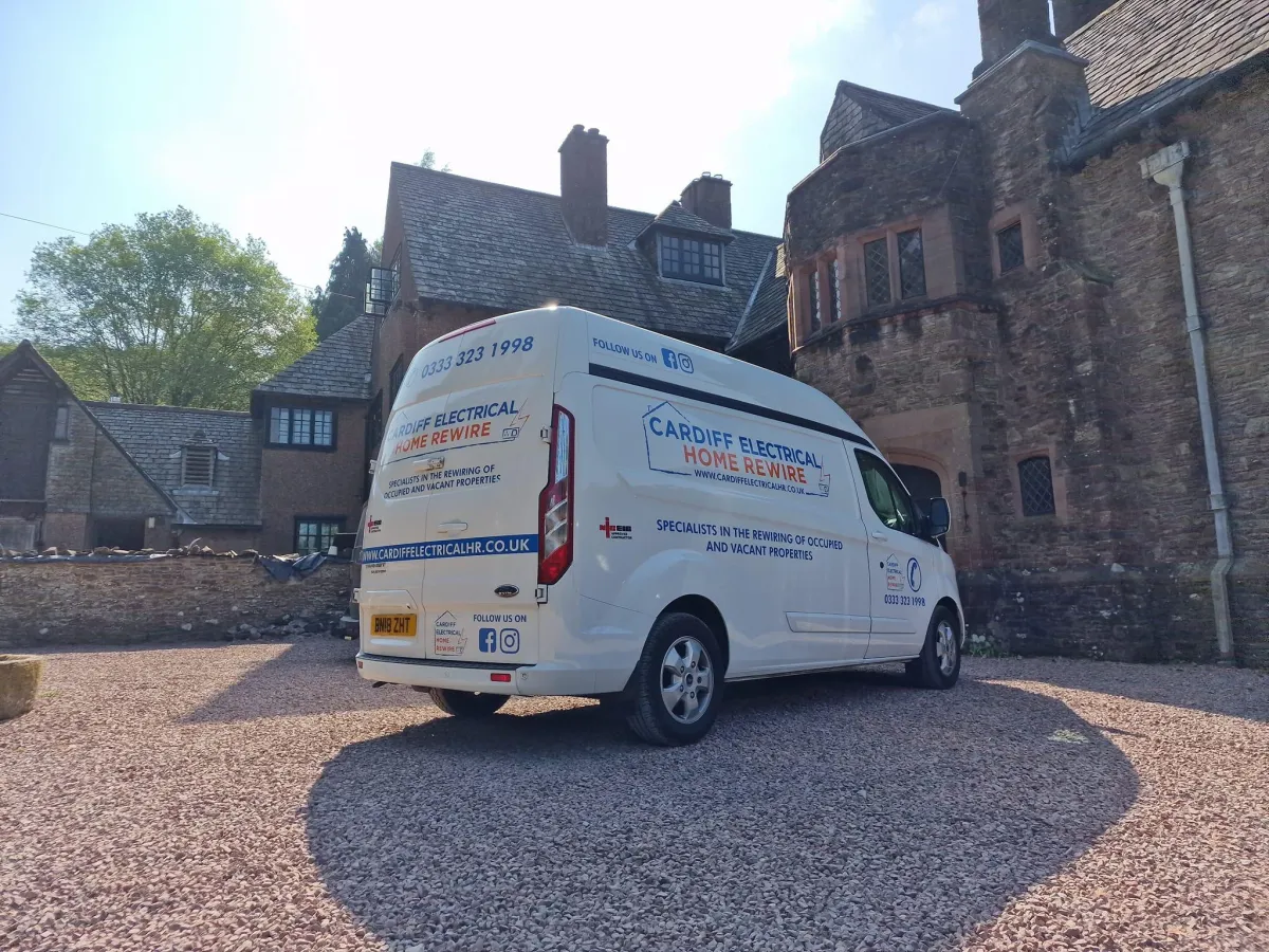 Cardiff Electrical Home Rewire Ltd branded van outside a period manor property in South Wales