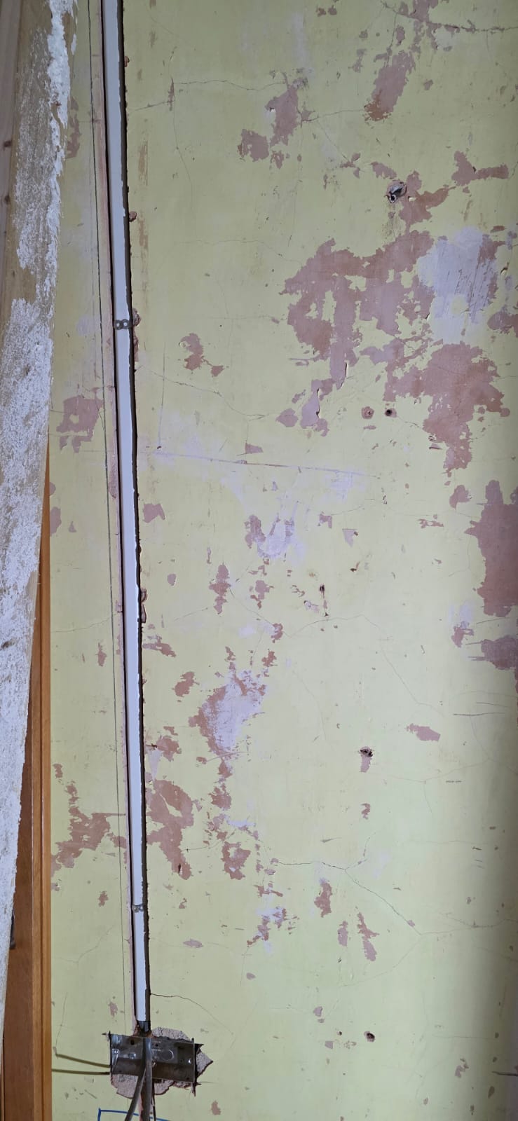 Old dangerous wiring exposed during a house rewire assessment