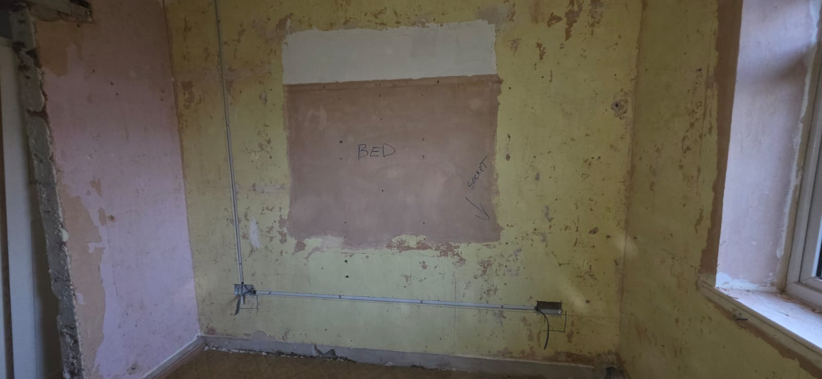 Bedroom rewire in progress showing new cable routes in a Cardiff home